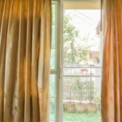 Sliding glass door with curtains partially drawn.