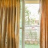 Sliding glass door with curtains partially drawn.