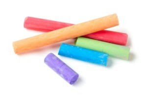 Colorful pieces of chalk on white background