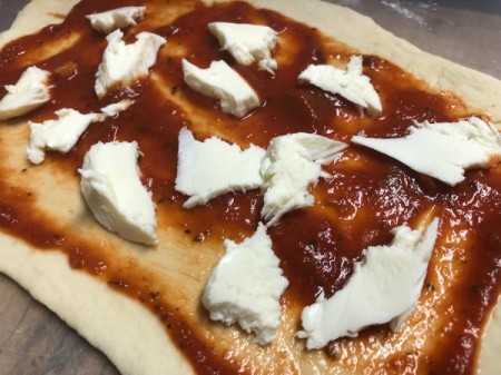 adding cheese to sauce