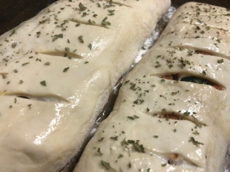 sprinkling oregano on Stromboli