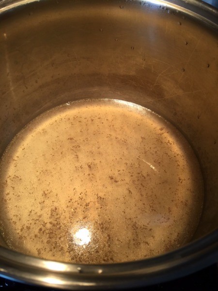 Coconut water and broth in pan