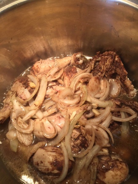 Chicken, onions and garlic added to coconut water