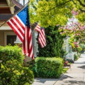 American Flags on houses in a neighborhood.