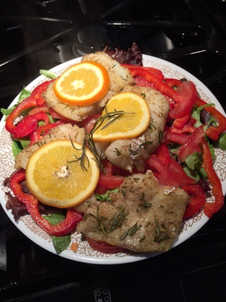 Baked Cod on bed of greens and red peppers