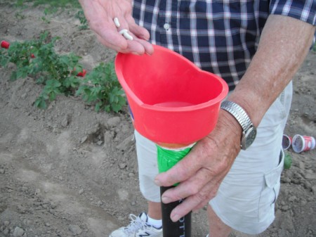 Planting Seed in the Garden - dropping seeds into funnel