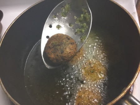 cooked Falafel lifted with slotted spoon