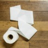 Toilet paper on a wood floor.
