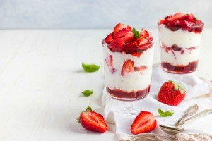 Strawberry and cream dessert in a glass.