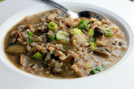 Mushroom and Wild
Rice Soup in a white bowl with a spoon