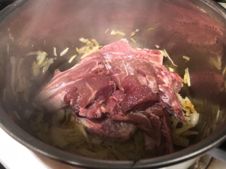 adding lamb to onions