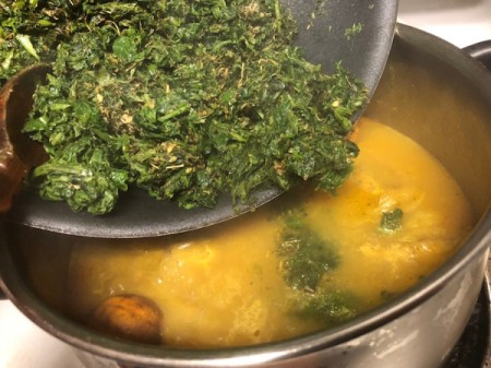 adding sautéed herbs to pot