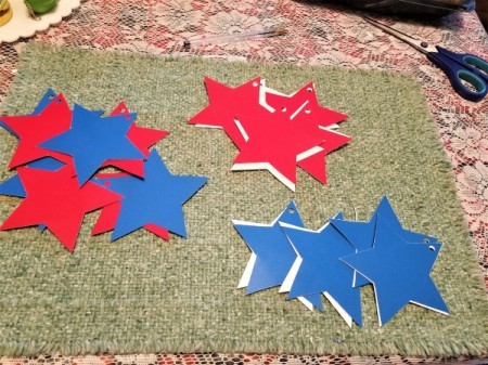 Red, White, and Blue Star Window Decor - punch a hole in one point, pair up two colors to hang on the yarn in your window