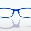 Blue eyeglass frames on white background.