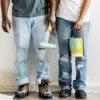 Two people with paint stains on their jeans.