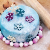 Blue cake with blue and pink snowflakes.