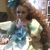 Value of a Cathay Collection Porcelain Doll - poor quality photo of doll with long curly hair