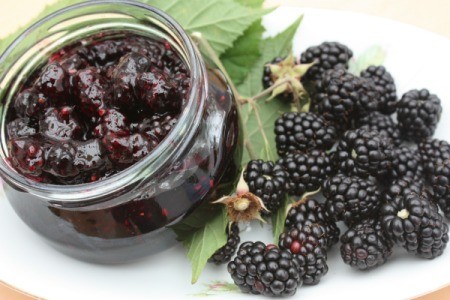 Blackberry Jam in a jar next to fresh blackberries