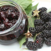 Blackberry Jam in a jar next to fresh blackberries