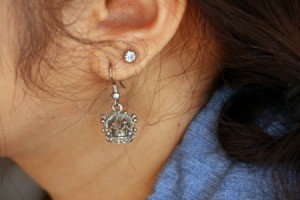 Silver earring in a woman's ear