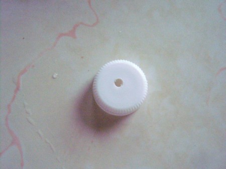 How to Make a Recycled Water Bottle Planter - hole punched in cap