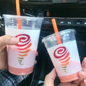 Two cups partially full of smoothie.