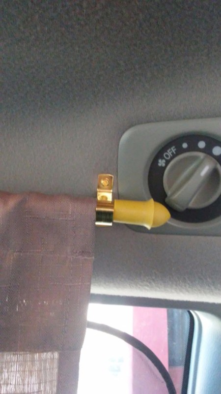 The hardware for a curtain rod in a minivan.
