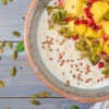 Tasty and healthy oatmeal porridge with mango, pomegranate and seeds.