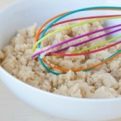 Raw cookie dough in a bowl with a colorful wisk.