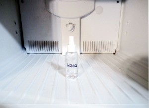 A clean freezer with a bottle of hydrogen peroxide.