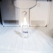 A clean freezer with a bottle of hydrogen peroxide.