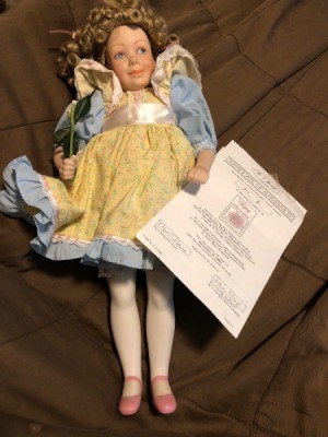Value of a Franklin Heirloom Porcelain Doll - doll in blue dress with yellow pinafore