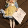 Value of a Franklin Heirloom Porcelain Doll - doll in blue dress with yellow pinafore