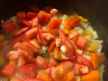 Tomatoes added to chopped vegetables