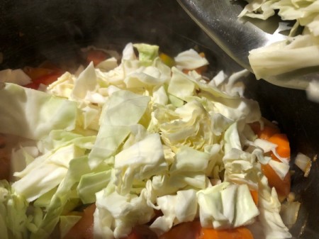 adding cabbage to veggies