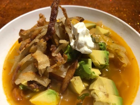 tortilla strips, avocado added to top of soup