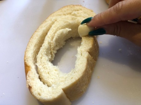 rubbing French bread with garlic