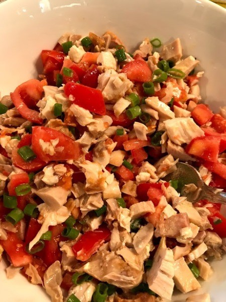 tossing ingredients with dressing