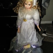 Finding the Value of Porcelain Dolls - doll wearing a white dress and hat