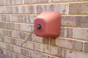 Faucet cover on a brick wall.