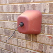 Faucet cover on a brick wall.