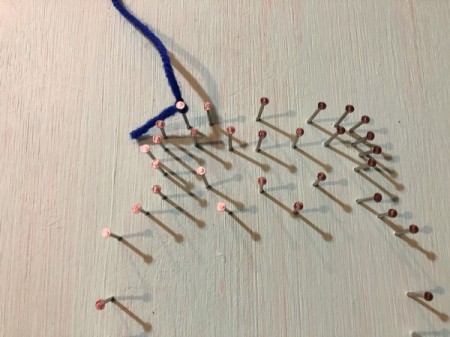 Yarn and Nail Wall-Hanging Vase - tie yarn to the upper left nail