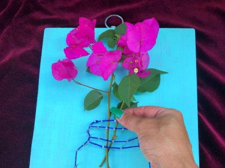 Yarn and Nail Wall-Hanging Vase - place cut flowers in jar