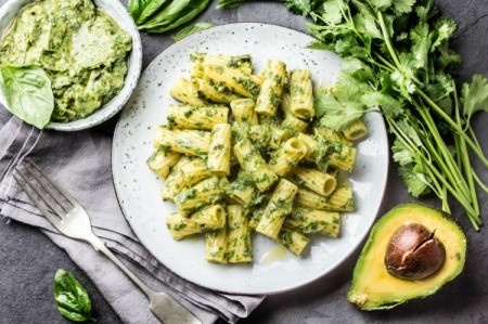 Vegan Pesto with penne pasta on white plate