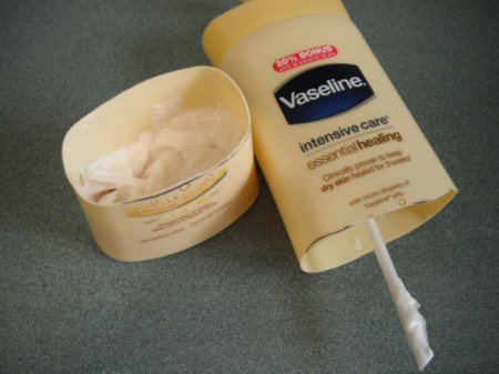 A bottle of lotion with the bottom removed.