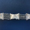 An old silver bracelet with a floral pattern.