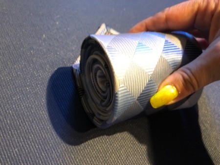 Floating Necktie Organizer - keep roll tight by rolling along one edge at wide end