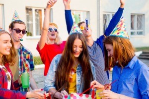 Teens having a party outside.