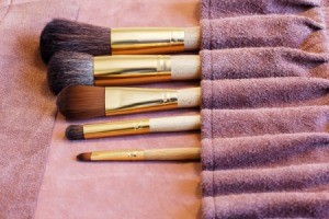 Makeup brushes in a roll-up case.
