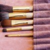 Makeup brushes in a roll-up case.